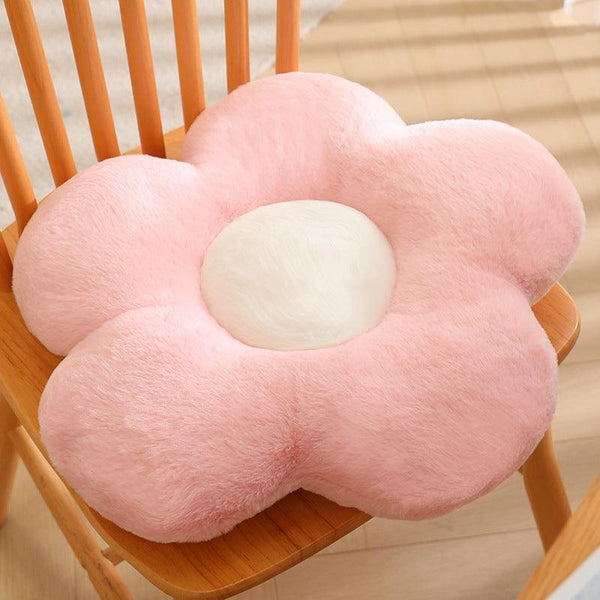 A soft pink petal-shaped pillow.