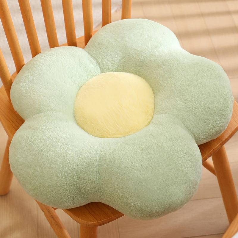 A soft petal-shaped pillow in mint color.