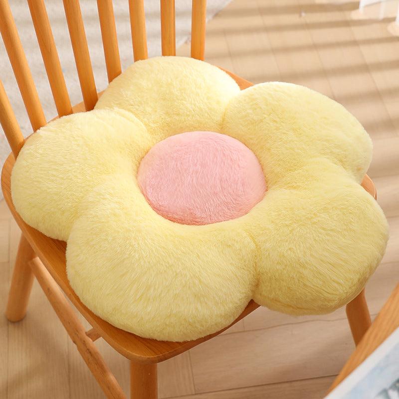 A soft yellow petal-shaped pillow.